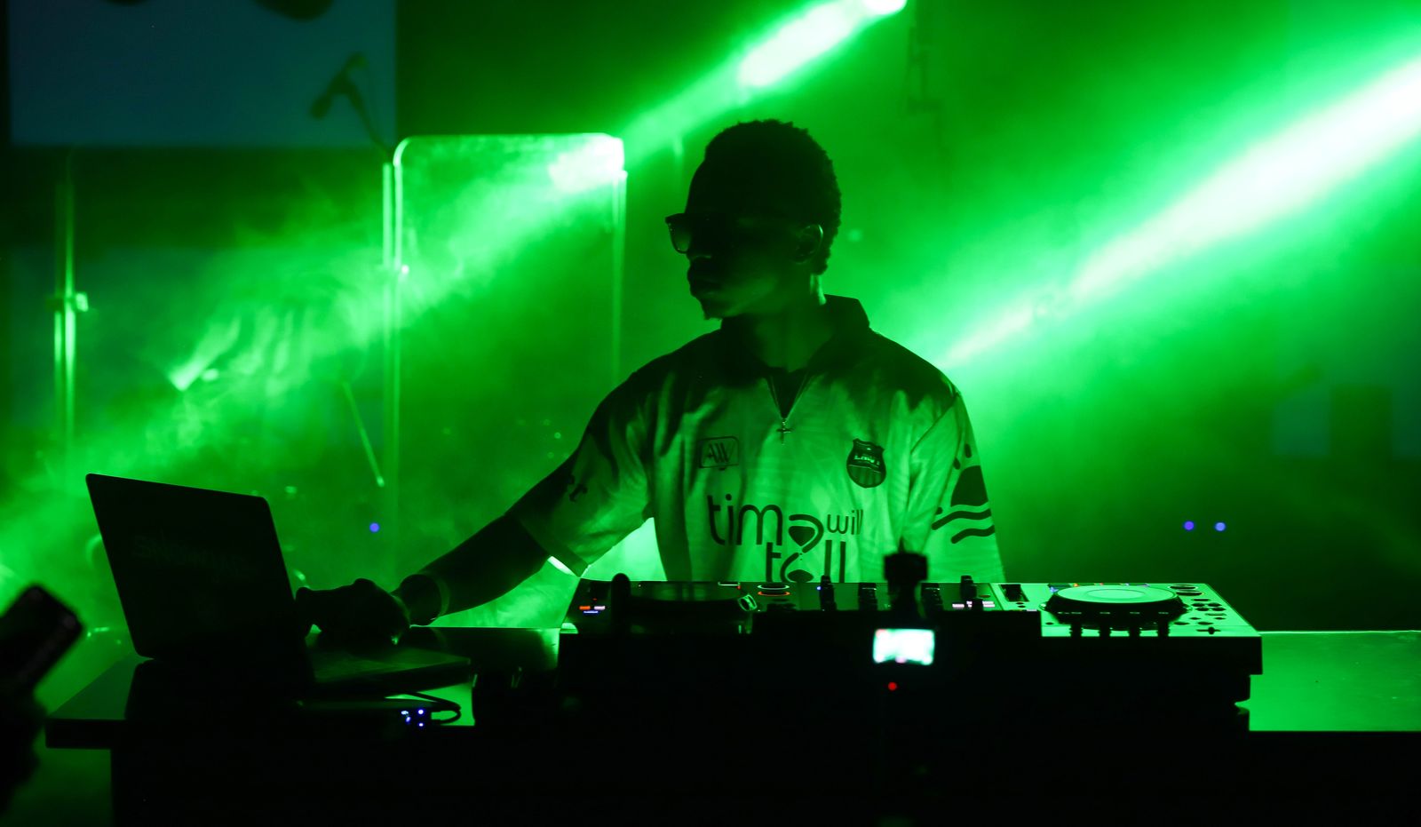 DJ under green lasers